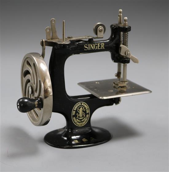 A childs toy Singer sewing machine by Dinger Manfg. Co